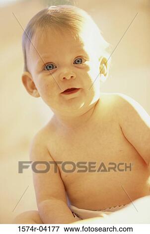 Stock Photo - Portrait of a baby boy sitting. Fotosearch