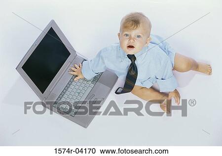 Portrait of a baby boy touching a laptop View Large Photo Image Stock Image - Portrait of a baby boy touching a laptop. Fotosearch
