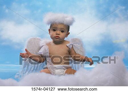 Stock Photo - Portrait of a baby girl dressed as an angel. Fotosearch