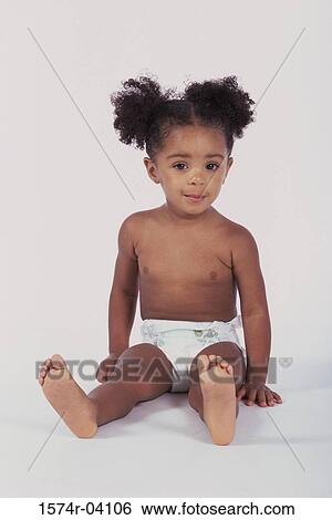Portrait of a baby girl sitting on the floor View Large Photo Image Stock Photograph - Portrait of a baby girl sitting on the floor. Fotosearch