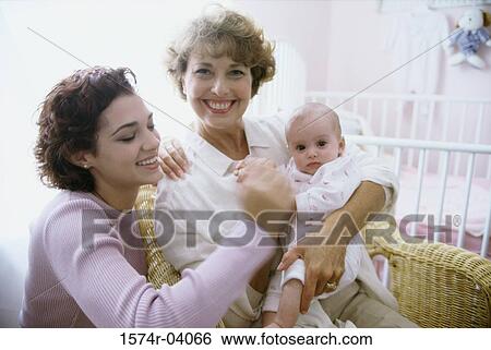 Portrait of a grandmother holding her granddaughter View Large Photo Image Stock Photograph - Portrait of a grandmother holding her granddaughter. Fotosearch