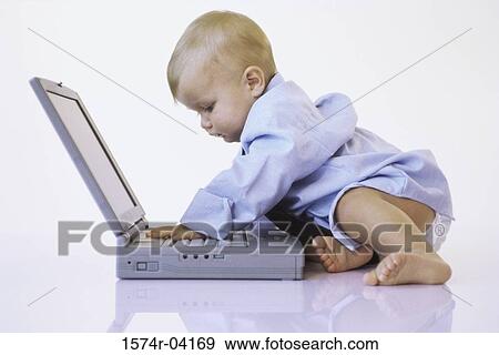 Side profile of a baby boy touching a laptop View Large Photo Image Stock Photo - Side profile of a baby boy touching a laptop. Fotosearch