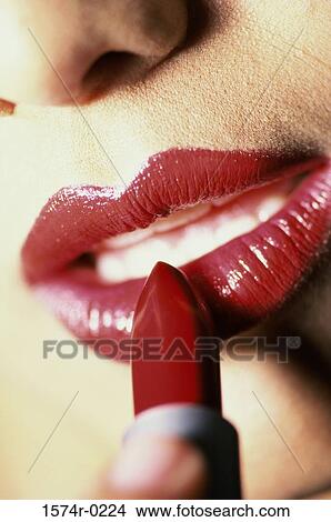 Close-up of a lipstick on a woman's lips View Large Photo Image Picture - Close-up of a lipstick on a woman's lips. Fotosearch