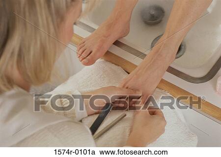 Close-up of a woman doing a pedicure View Large Photo Image Stock Image - Close-up of a woman doing a pedicure. Fotosearch