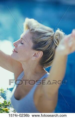 Stock Image - Close-up of a woman exercising with her eyes closed. Fotosearch