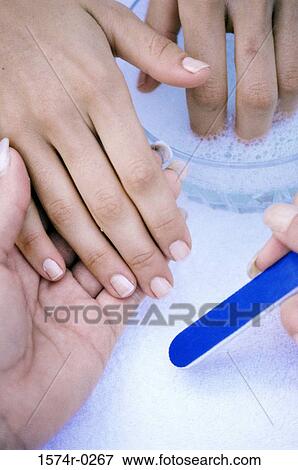 Close-up of a woman's hand getting a manicure View Large Photo Image Stock Photo - Close-up of a woman's hand getting a manicure. Fotosearch