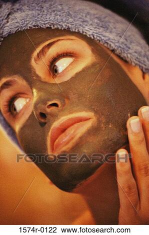 Close-up of a young woman applying a facial mask with her finger View Large Photo Image Stock Image - Close-up of a young woman applying a facial mask with her finger. Fotosearch