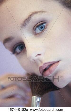Close-up of a young woman applying blush View Large Photo Image Stock Image - Close-up of a young woman applying blush. Fotosearch