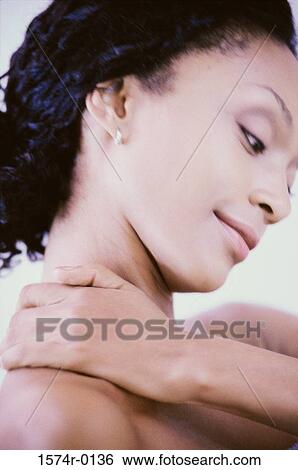 Close-up of a young woman applying moisturizer on her neck View Large Photo Image Stock Photograph - Close-up of a young woman applying moisturizer on her neck. Fotosearch
