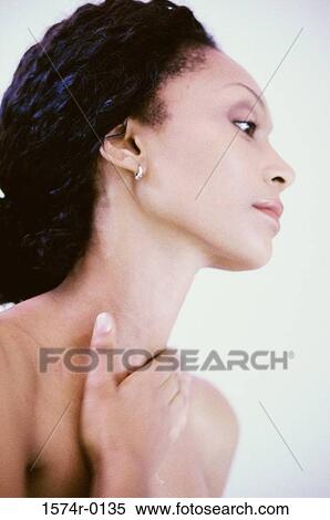 Close-up of a young woman applying moisturizer on her neck View Large Photo Image Stock Photography - Close-up of a young woman applying moisturizer on her neck. Fotosearch