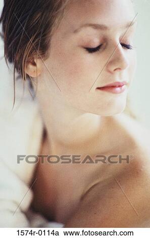 Close-up of a young woman lying with her eyes closed View Large Photo Image Stock Image - Close-up of a young woman lying with her eyes closed. Fotosearch