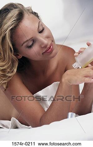 Close-up of a young woman pouring moisturizer on her hand View Large Photo Image Stock Image - Close-up of a young woman pouring moisturizer on her hand. Fotosearch