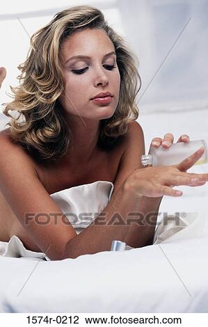 Close-up of a young woman pouring moisturizer on her hand View Large Photo Image Stock Image - Close-up of a young woman pouring moisturizer on her hand. Fotosearch