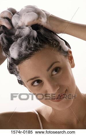 Close-up of a young woman shampooing her hair View Large Photo Image Stock Photography - Close-up of a young woman shampooing her hair. Fotosearch
