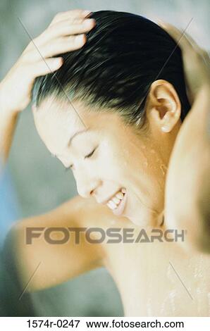 Close-up of a young woman taking a shower View Large Photo Image Stock Photo - Close-up of a young woman taking a shower. Fotosearch