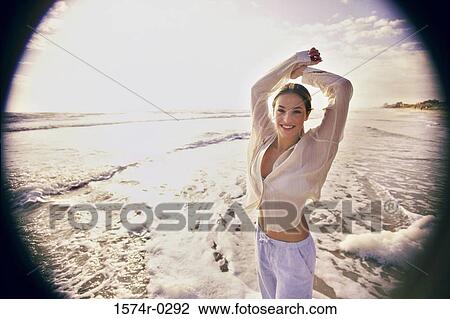 Portrait of a young woman at the beach View Large Photo Image Stock Image - Portrait of a young woman at the beach. Fotosearch