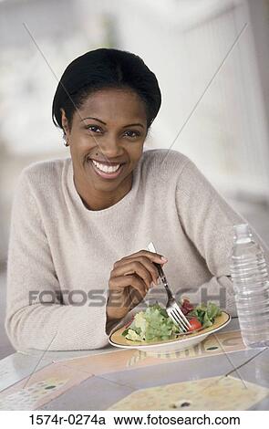 Portrait of a young woman eating salad View Large Photo Image Stock Image - Portrait of a young woman eating salad. Fotosearch