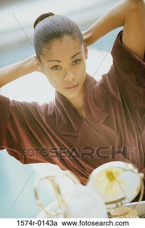 Portrait of a young woman wearing a bathrobe View Large Photo Image Stock Image - Portrait of a young woman wearing a bathrobe. Fotosearch