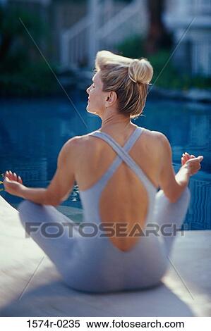 Rear view of mid adult woman sitting on the floor meditating View Large Photo Image Stock Photography - Rear view of mid adult woman sitting on the floor meditating. Fotosearch