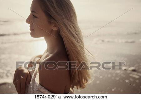 Side profile of a young woman at the beach View Large Photo Image Stock Image - Side profile of a young woman at the beach. Fotosearch
