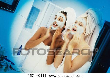 Two young women wearing facial masks View Large Photo Image Stock Image - Two young women wearing facial masks. Fotosearch