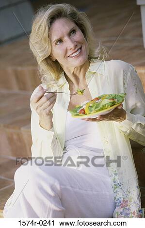 Woman eating salad with a fork View Large Photo Image Stock Image - Woman eating salad with a fork. Fotosearch