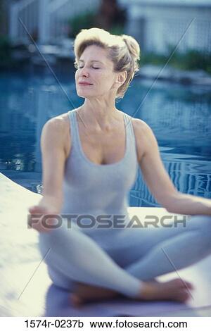 Woman meditating with her eyes closed View Large Photo Image Stock Image - Woman meditating with her eyes closed. Fotosearch