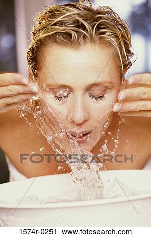 Woman washing her face View Large Photo Image Stock Image - Woman washing her face. Fotosearch
