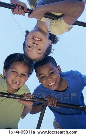 Close-up of two boys and a girl playing on monkey bars View Large Photo Image Stock Image - Close-up of two boys and a girl playing on monkey bars. Fotosearch