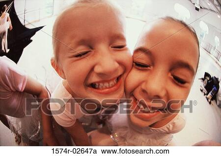 Close-up of two girls smiling View Large Photo Image Stock Image - Close-up of two girls smiling. Fotosearch