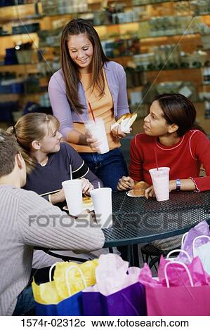 Group of teenagers at a shopping mall cafe View Large Photo Image Stock Image - Group of teenagers at a shopping mall cafe. Fotosearch