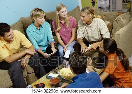 Stock Image - Group of teenagers having a group discussion. Fotosearch