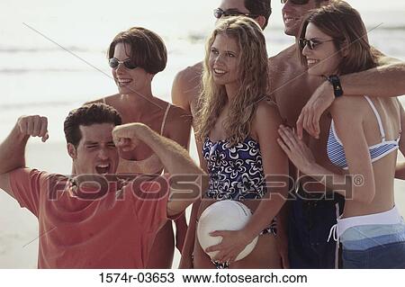Group of young couples on the beach View Large Photo Image Stock Image - Group of young couples on the beach. Fotosearch