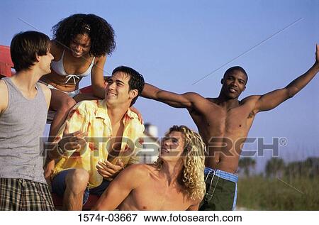 Group of young people on the beach View Large Photo Image Stock Photo - Group of young people on the beach. Fotosearch