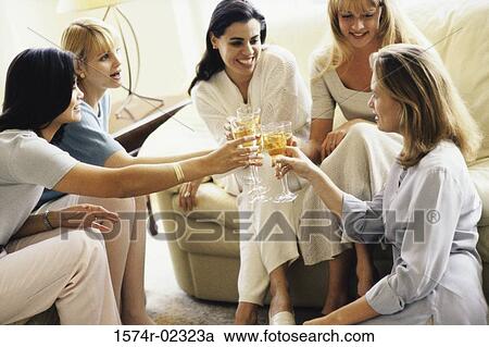 Group of young women sitting together View Large Photo Image Stock Image - Group of young women sitting together. Fotosearch