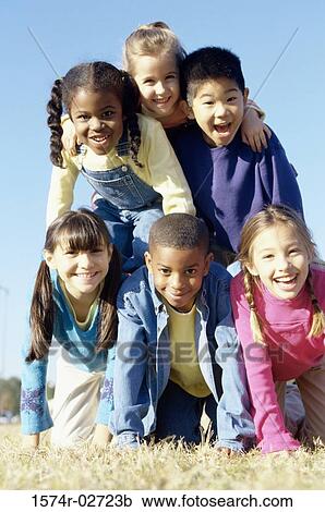 Stock Image - Portrait of a group of children making a human pyramid. Fotosearch