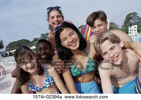 Portrait of a group of teenagers sitting beside a swimming pool View Large Photo Image Stock Image - Portrait of a group of teenagers sitting beside a swimming pool. Fotosearch
