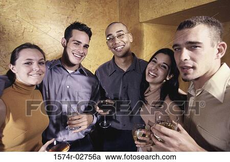 Stock Image - Portrait of a group of young people in a bar. Fotosearch