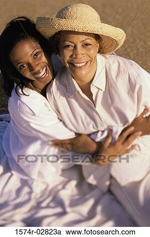 Portrait of a mother and her daughter smiling View Large Photo Image Stock Image - Portrait of a mother and her daughter smiling. Fotosearch