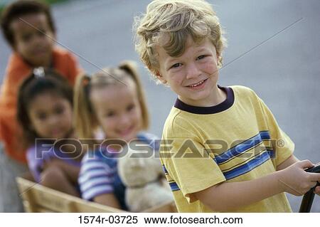 Portrait of two boys and two girls playing with a push cart View Large Photo Image Stock Photography - Portrait of two boys and two girls playing with a push cart. Fotosearch