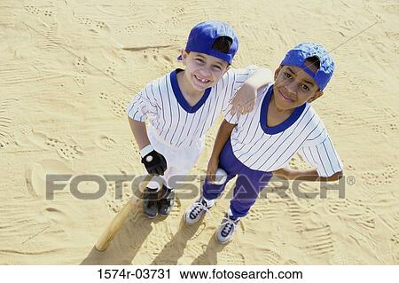 Portrait of two boys in baseball uniforms View Large Photo Image Stock Image - Portrait of two boys in baseball uniforms. Fotosearch