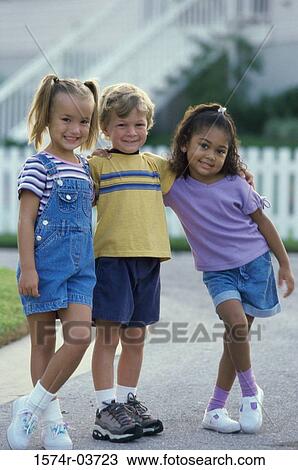 Portrait of two girls and a boy standing together View Large Photo Image Stock Image - Portrait of two girls and a boy standing together. Fotosearch