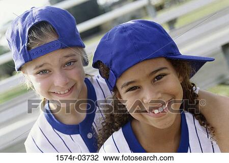 Portrait of two girls in baseball uniforms View Large Photo Image Stock Image - Portrait of two girls in baseball uniforms. Fotosearch