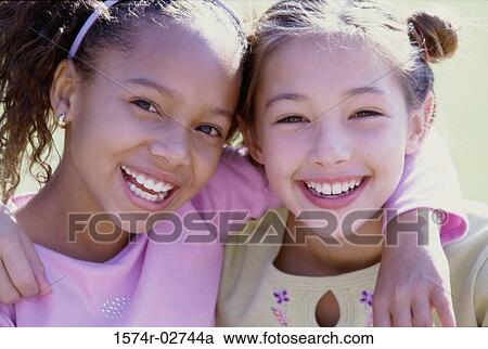 Portrait of two girls smiling View Large Photo Image Stock Image - Portrait of two girls smiling. Fotosearch
