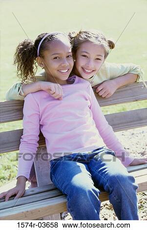 Portrait of two girls smiling View Large Photo Image Stock Photo - Portrait of two girls smiling. Fotosearch