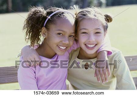 Portrait of two girls smiling View Large Photo Image Stock Photo - Portrait of two girls smiling. Fotosearch