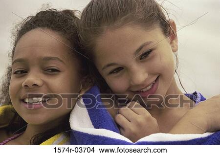Portrait of two girls wrapped in a towel View Large Photo Image Picture - Portrait of two girls wrapped in a towel. Fotosearch