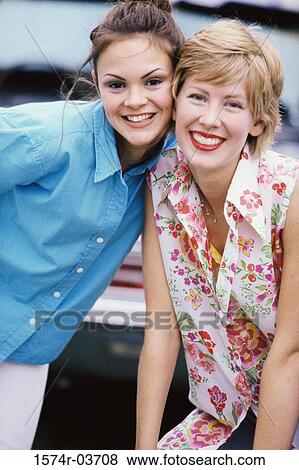 Stock Photo - Portrait of two young women smiling. Fotosearch