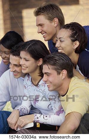Stock Image - Side profile of a group of teenagers smiling. Fotosearch