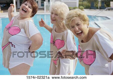 Stock Image - Three senior women standing near a swimming pool. Fotosearch